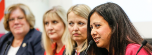 Women speaking into a microphone